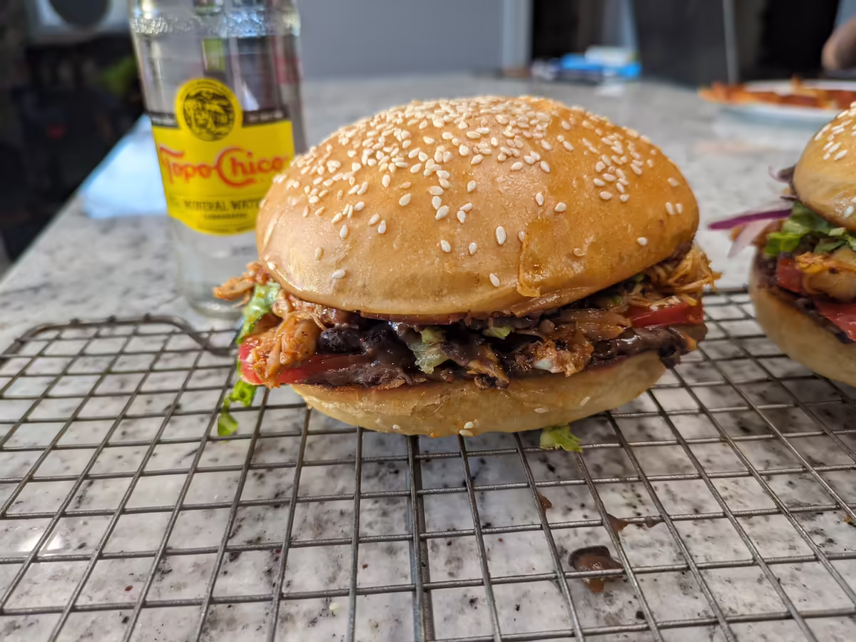 chicken cutlet sandwich with an orange sauce dripping out