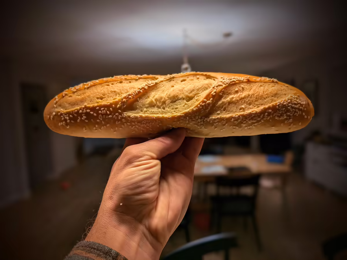 handful of hoagie rolls, the one in focus is nestled on top of others and slanted upwards
