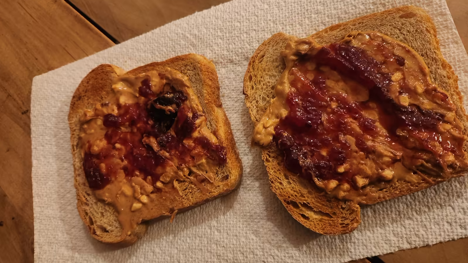 two open-faced PB&J slices looking real tasty